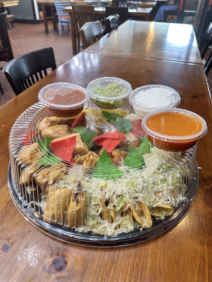 Sealed Party Platter tray with lid on, dip cups arranged around the perimeter, ready for pickup or delivery